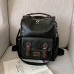 Vintage zwart kunstlederen rugzak met beige zitvlak