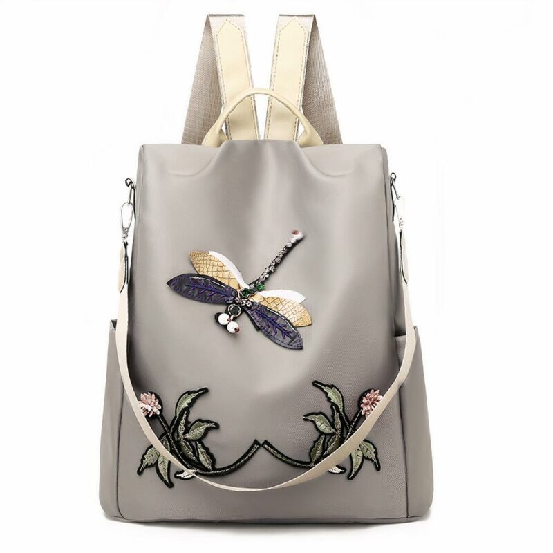 Damesrugzak met geborduurde bloemen en vlinder in beige en grijs met witte achtergrond